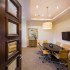 Modern conference room with large table and office chairs.