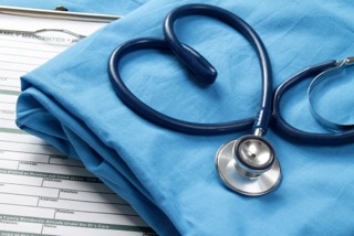 Blue stethoscope shaped like a heart on medical scrubs.