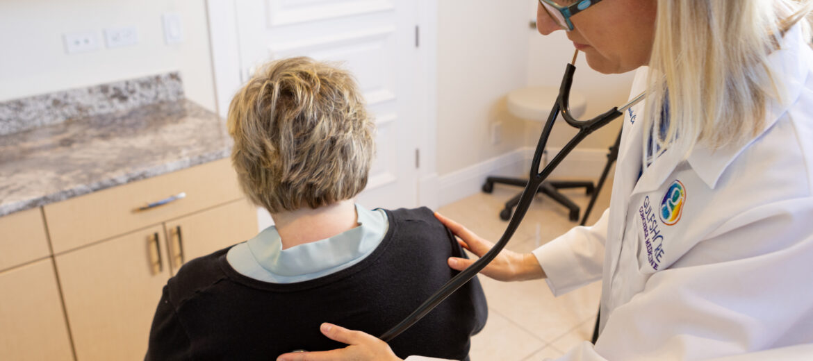 Doctor examining patient with stethoscope.