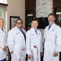 Gulfshore_Concierge_Medicine_2024_Group_Shot_@ ES9_Photography_2024-66 Four professionals in white lab coats.